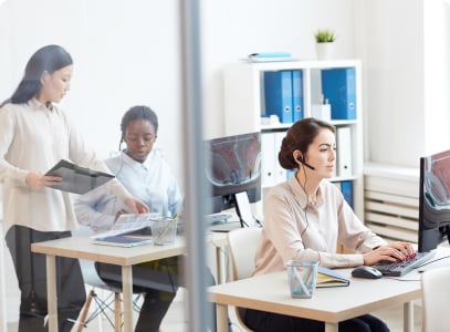 women with headset, working in her computer in office 