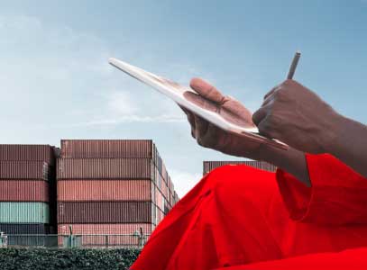 person writing with containers in the background