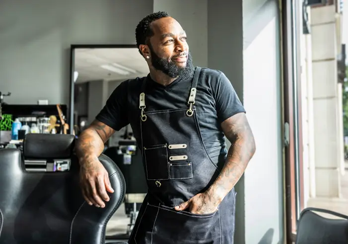 Image of barber staring into the distance
