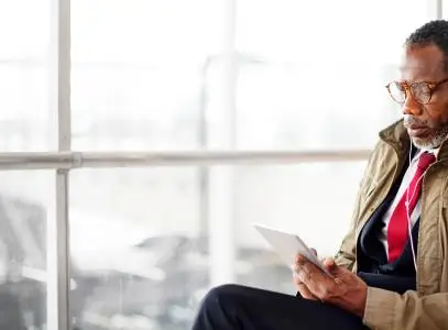 Man looking at his tablet