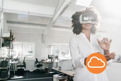 women using VR googles in the office space with an AWS logo