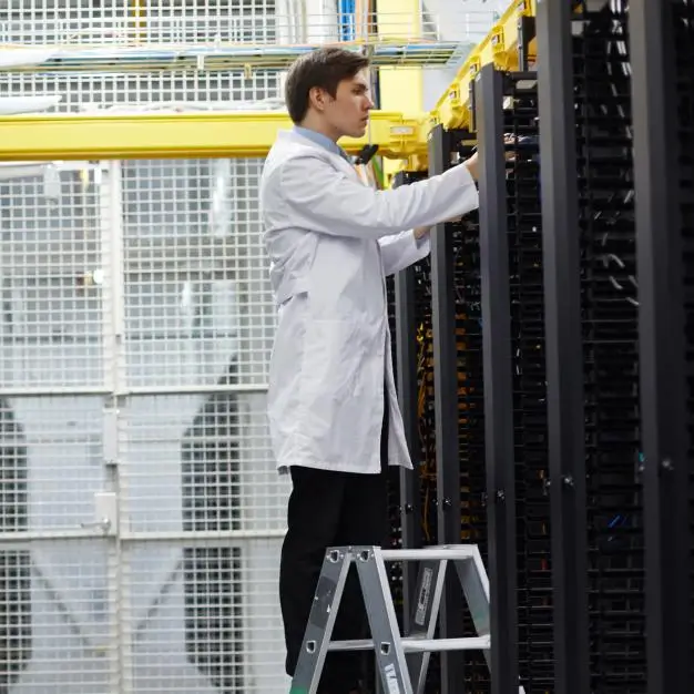 man standing on step ladder working on a server