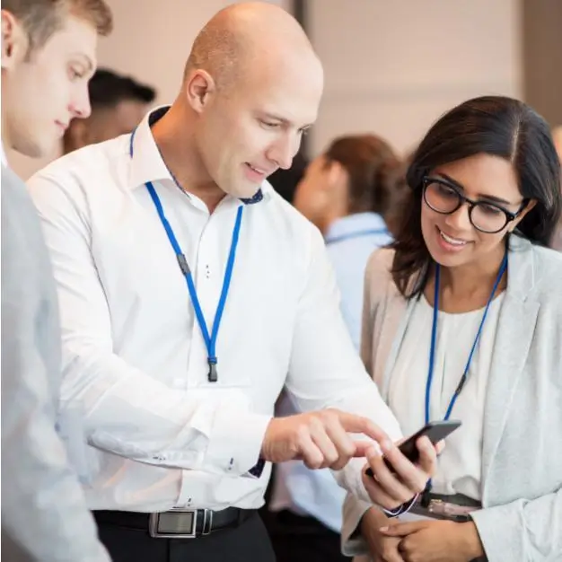Two businesspeople look at a smartphone together