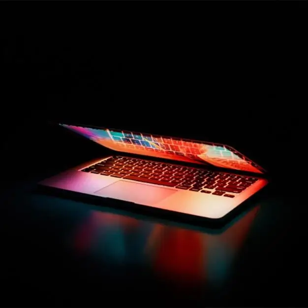 laptop with glowing pinks and oranges 