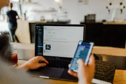 person working from a laptop and screen
