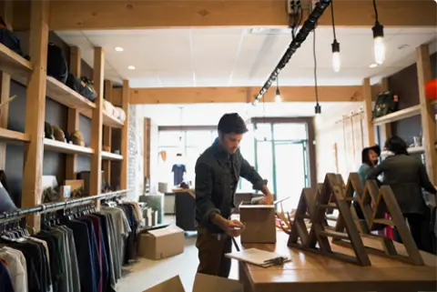 Person working from table in a clothing shop