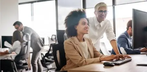 Two women working together looking at a screen