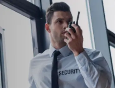 A securty officer talking over his radio