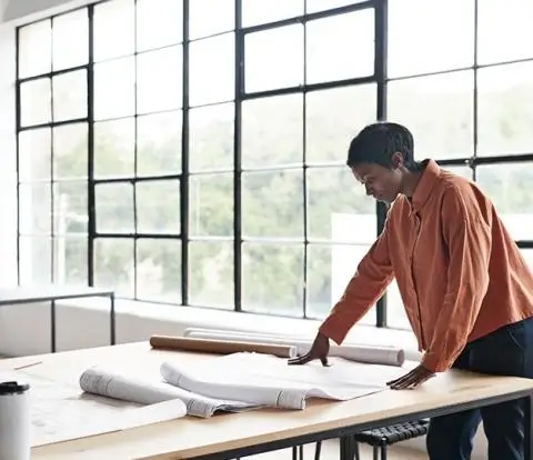 A women looking at plans on a table