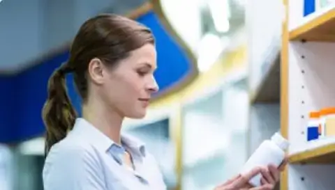 woman looking at medication