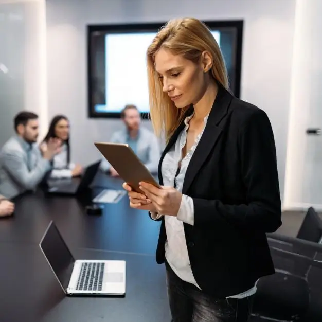 Woman working from tablet in a boardroom