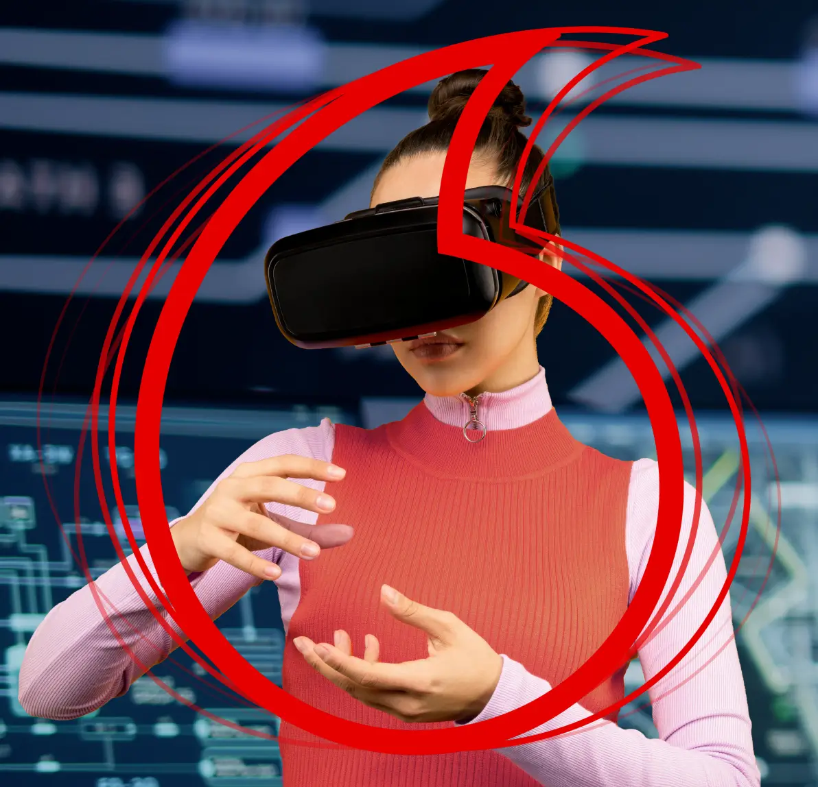 A smiling man wearing glasses works at a computer desk with code on the monitors, overlaid with a large red Vodafone logo.